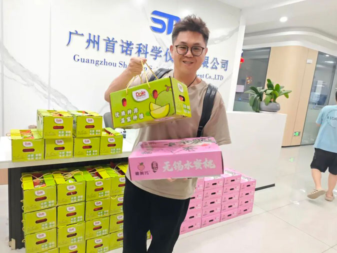 Shounuo team members collecting their gifts with smiles